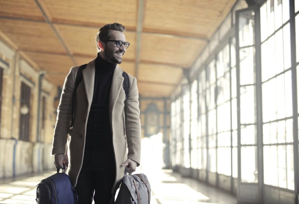 pexels-photo-837129 Man in Brown Robe Carrying Bag Smiling
